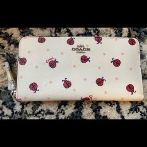 NWT Coach zip around wallet.